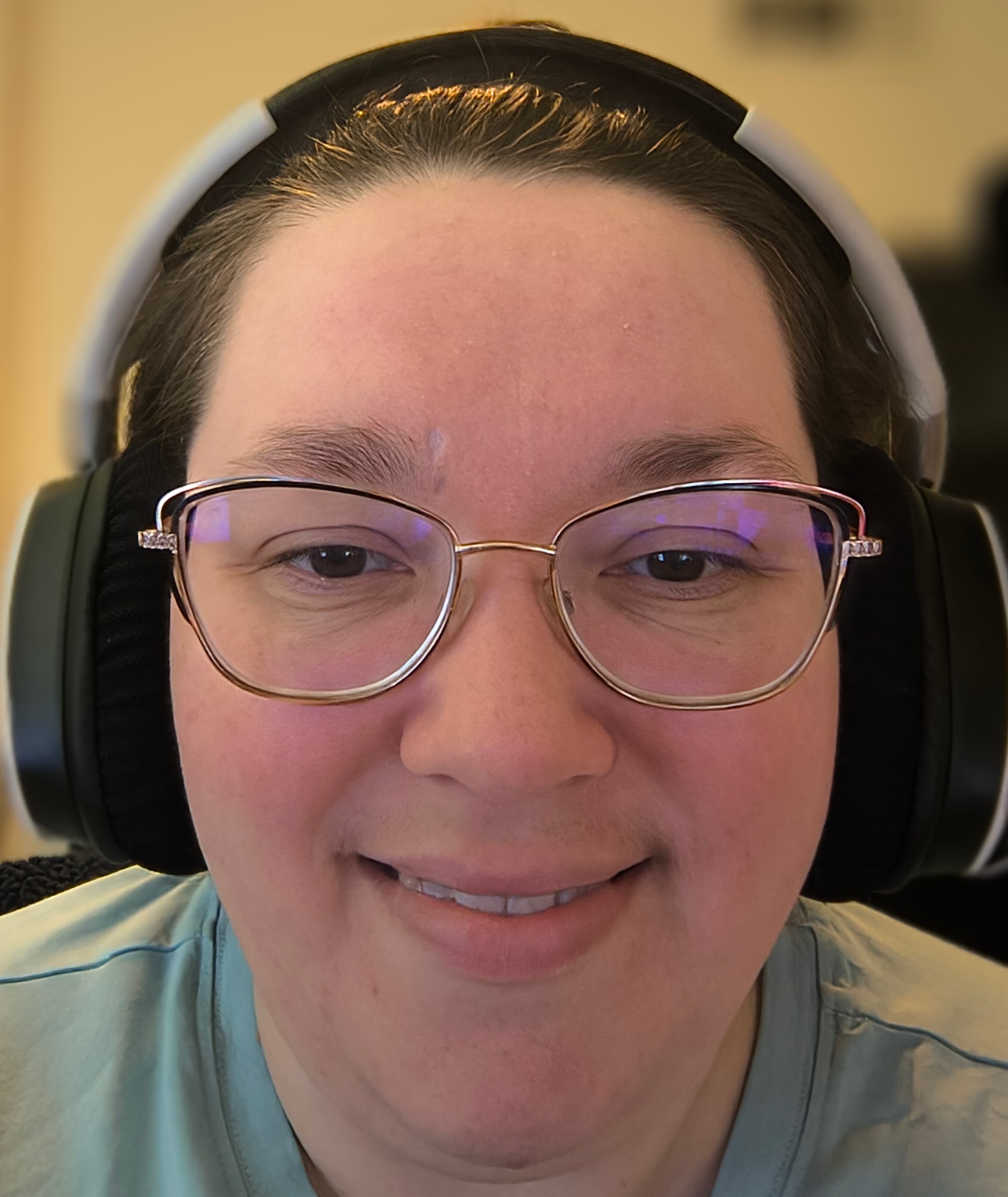 female with glasses with smile on face